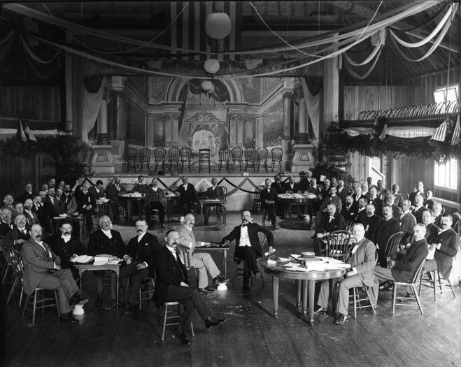 An old black and white photo of a large meeting