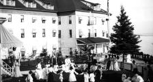 An old black and white photo of women and children playing outdoors