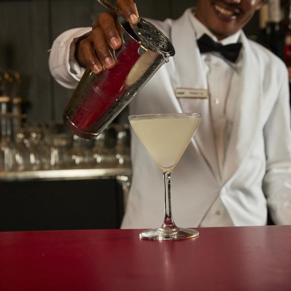 Bartender pouring a cocktail