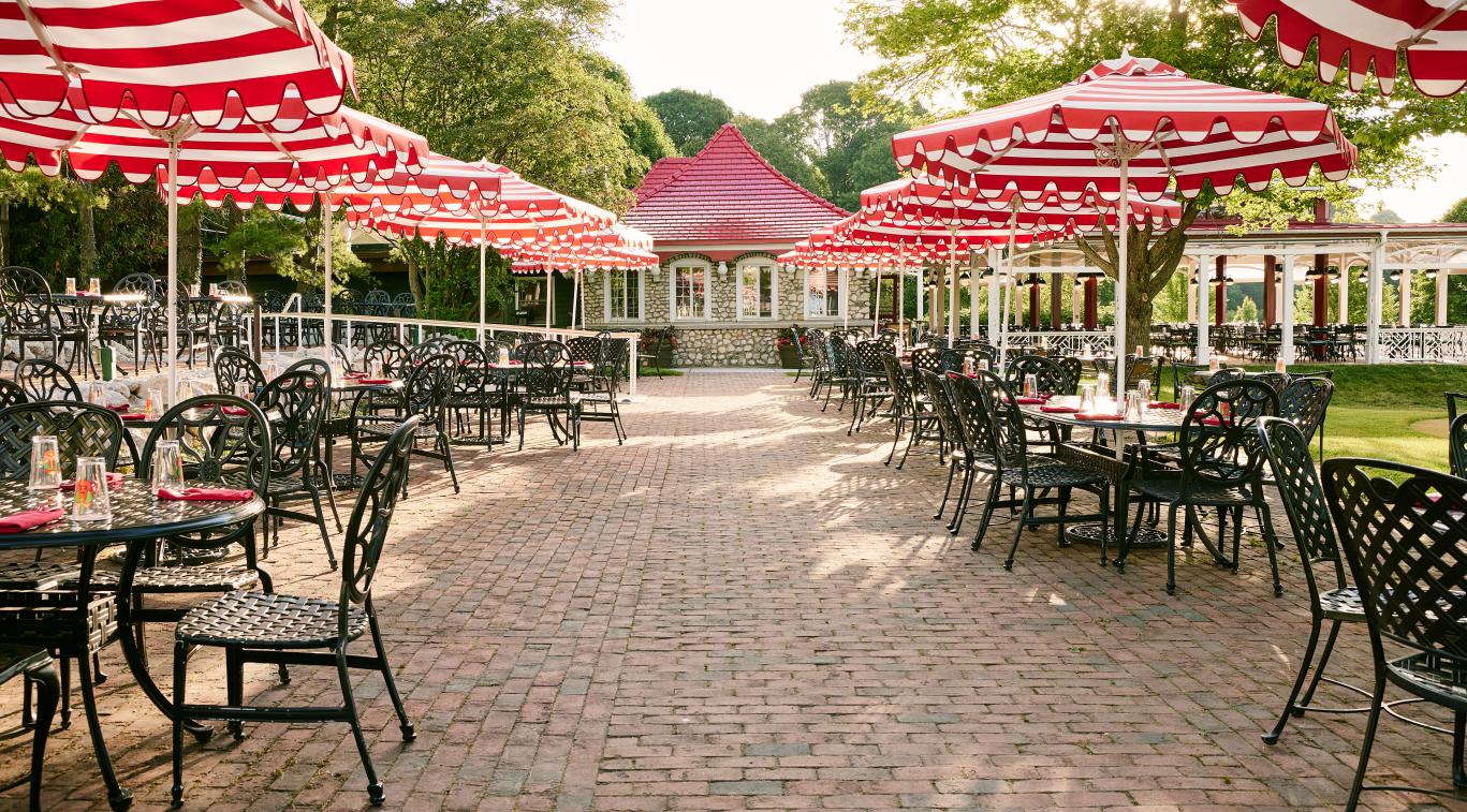 Patio with red and white striped umbrellas at The Jockey Club.