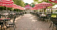 Patio with red and white striped umbrellas at The Jockey Club.