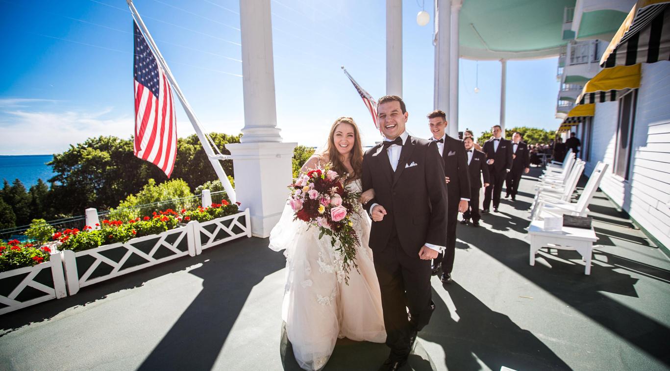 A newly married couple smiling on the porch