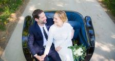 A couple sitting in a carriage on their wedding day