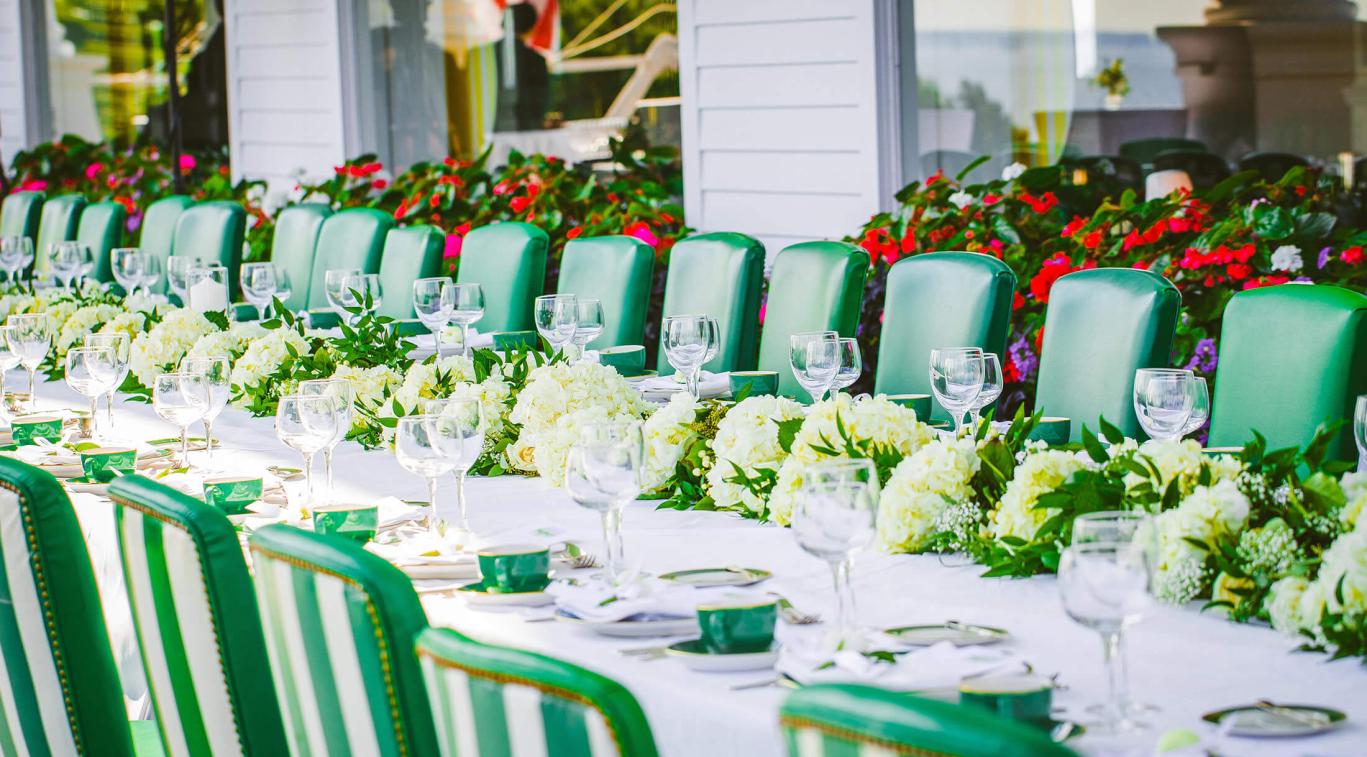 A long wedding dinner table set for many guests