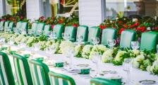 A long wedding dinner table set for many guests