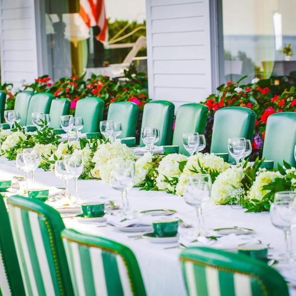 A long wedding dinner table set for many guests