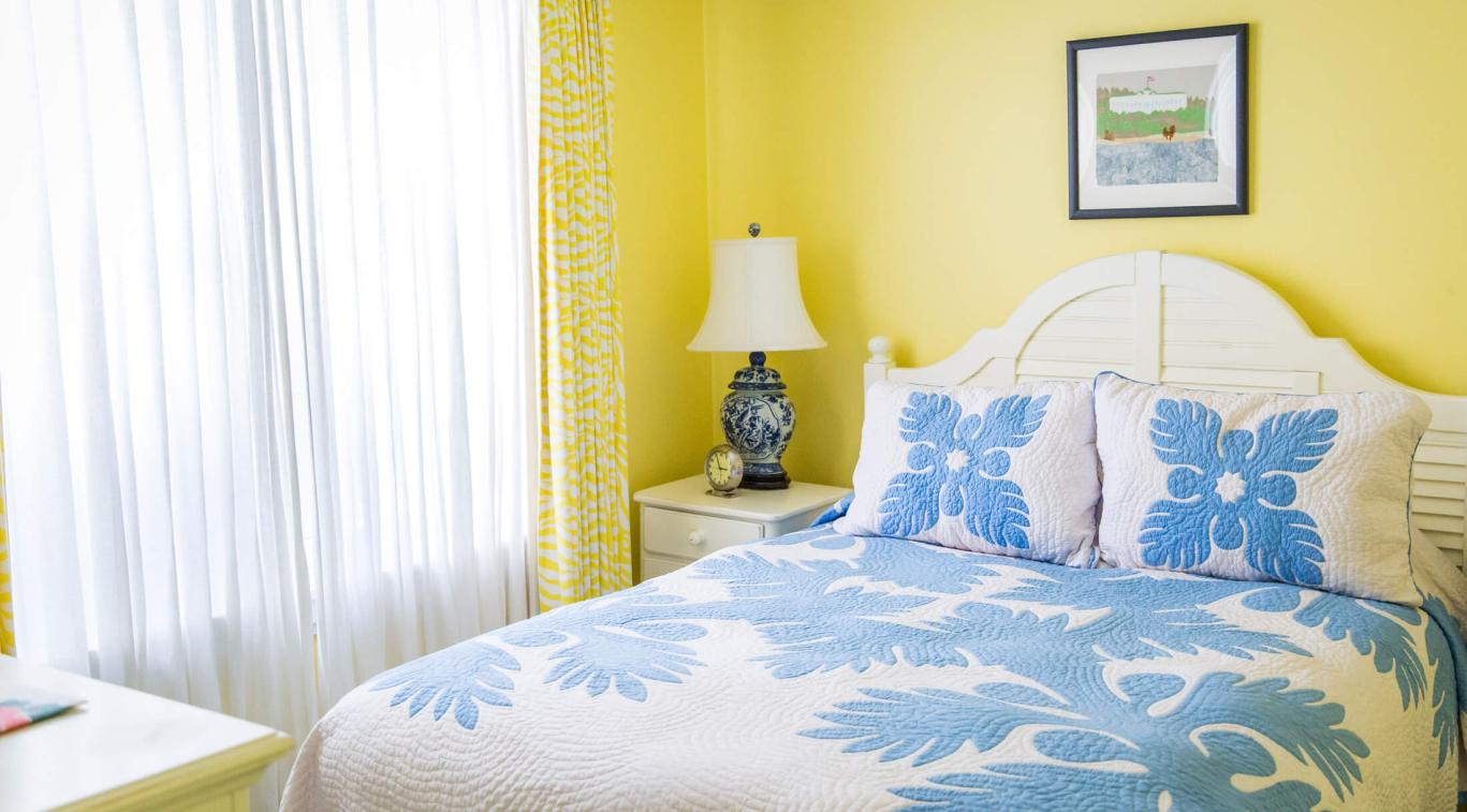 A yellow bedroom in Masco Cottage