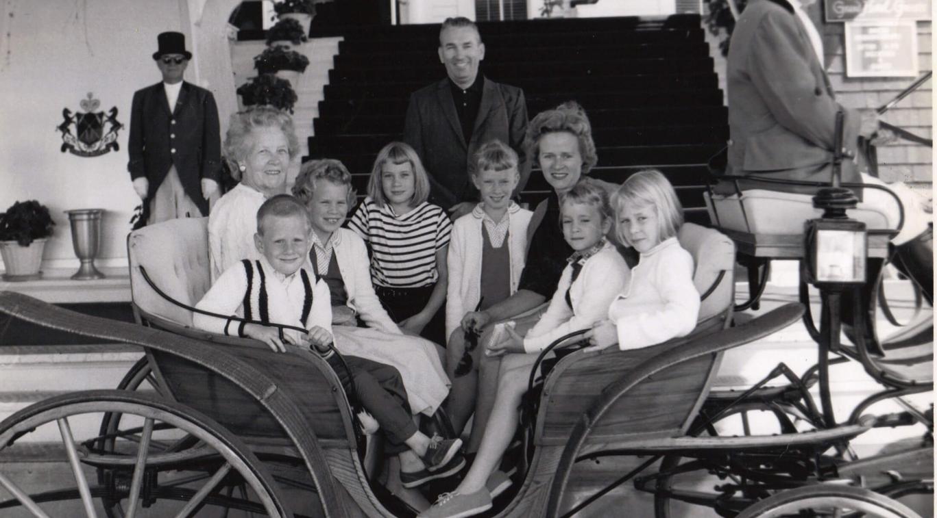 An old black and white photo of a family in a carriage