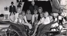 An old black and white photo of a family in a carriage