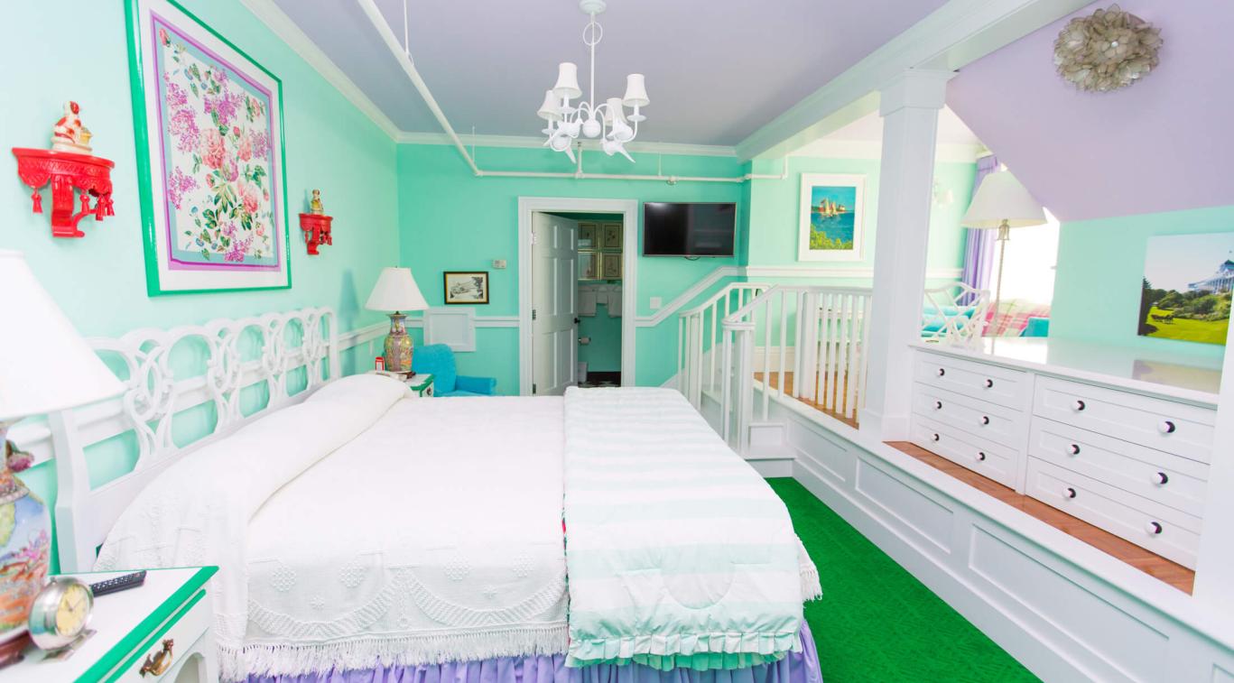 A long bedroom in Cupola Suites