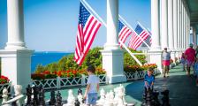 Children playing with large chess board on front porch