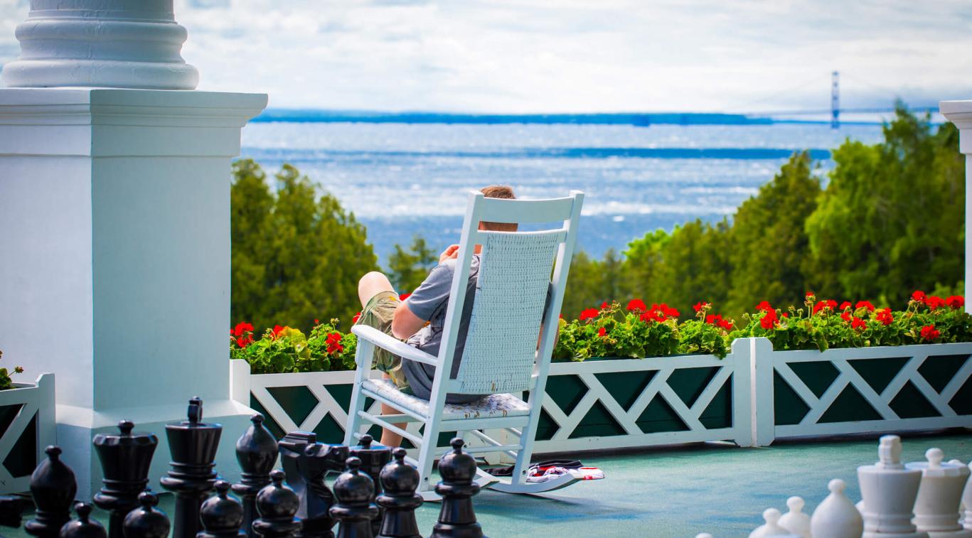 Man sitting in rocking chair on front porch