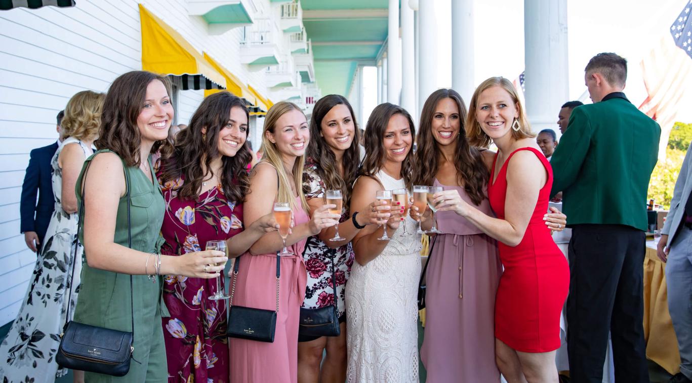 Groups of women with wine glasses on front porch