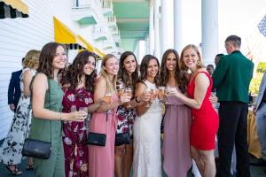 Groups of women with wine glasses on front porch