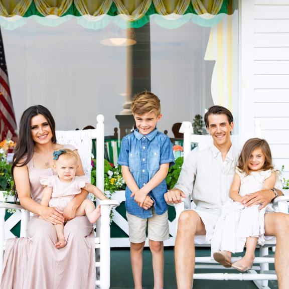Children with parents on front porch