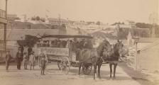 An old black and white photo of a horse-drawn carriage