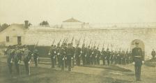 An old black and white photo of soldiers during a parade