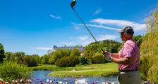 Plan golfing near pond with Grand Hotel in far background