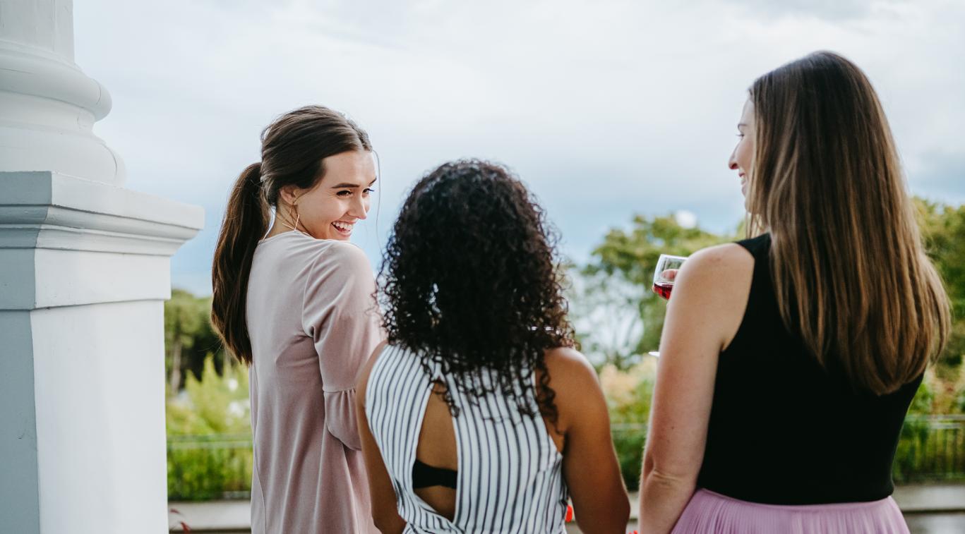 Three women enjoying a conversation.