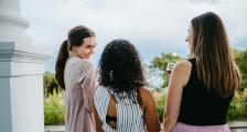 Three women enjoying a conversation.