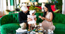 Mother and Father with child sitting on couch in Grand Hotel