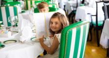 girl holding menu at dinner table