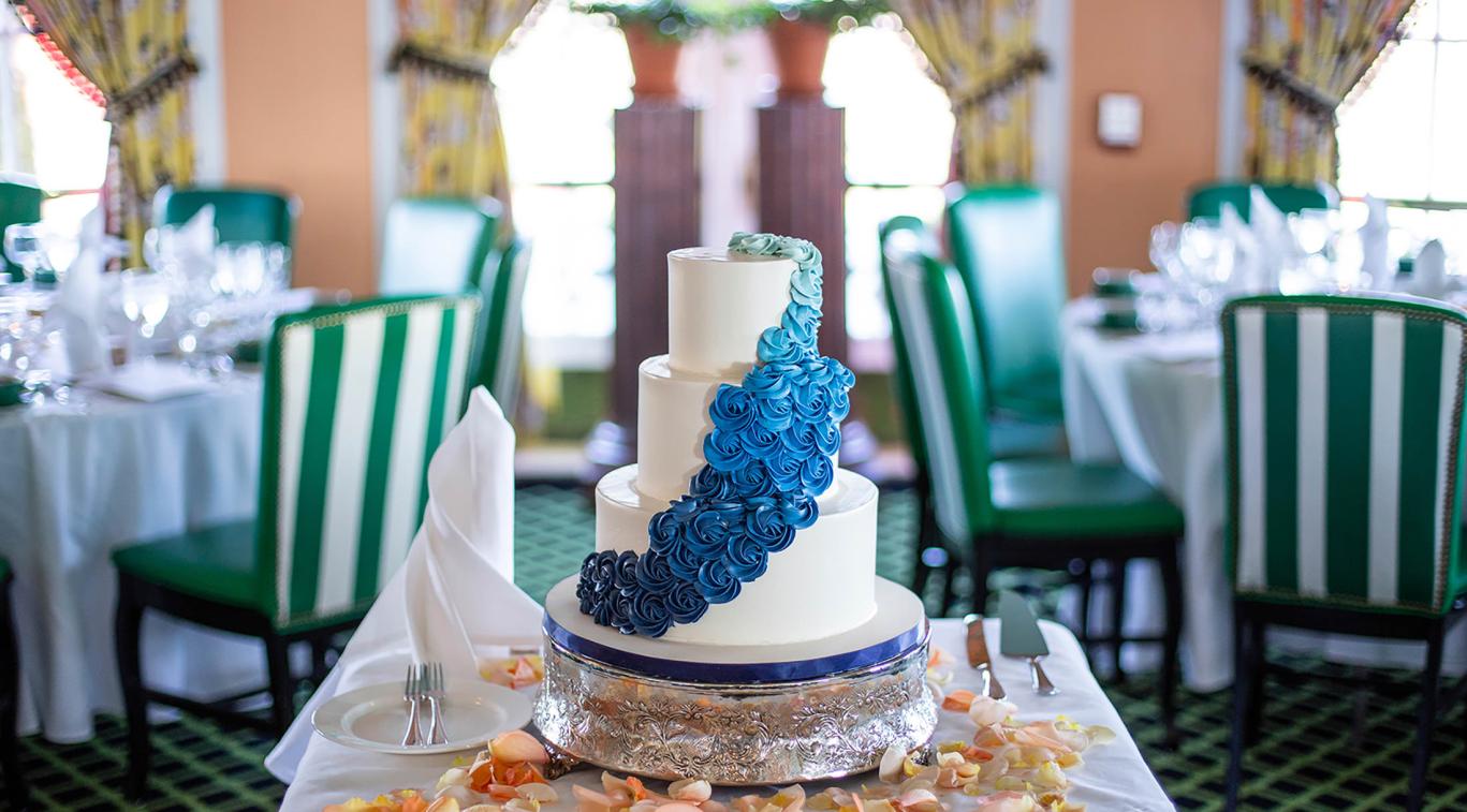 A wedding cake on a table at a reception