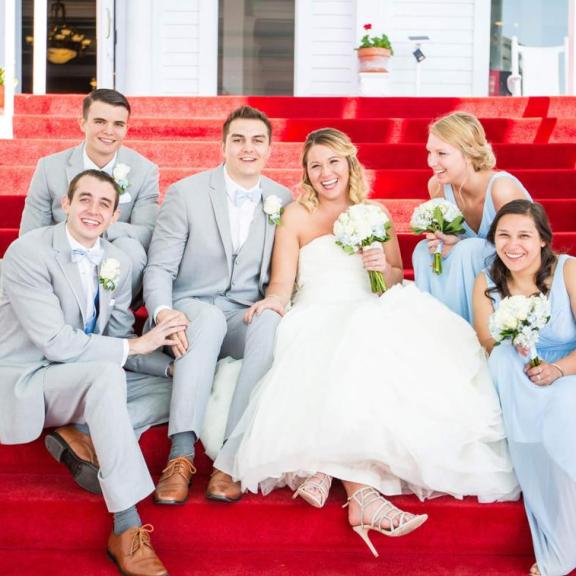 A bridal party sitting on the steps
