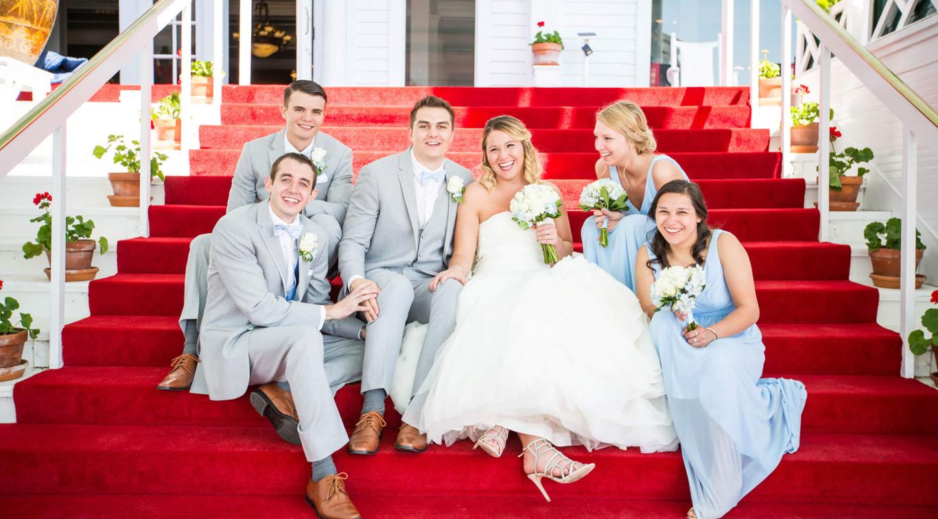 A bridal party sitting on the steps