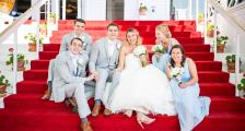A bridal party sitting on the steps