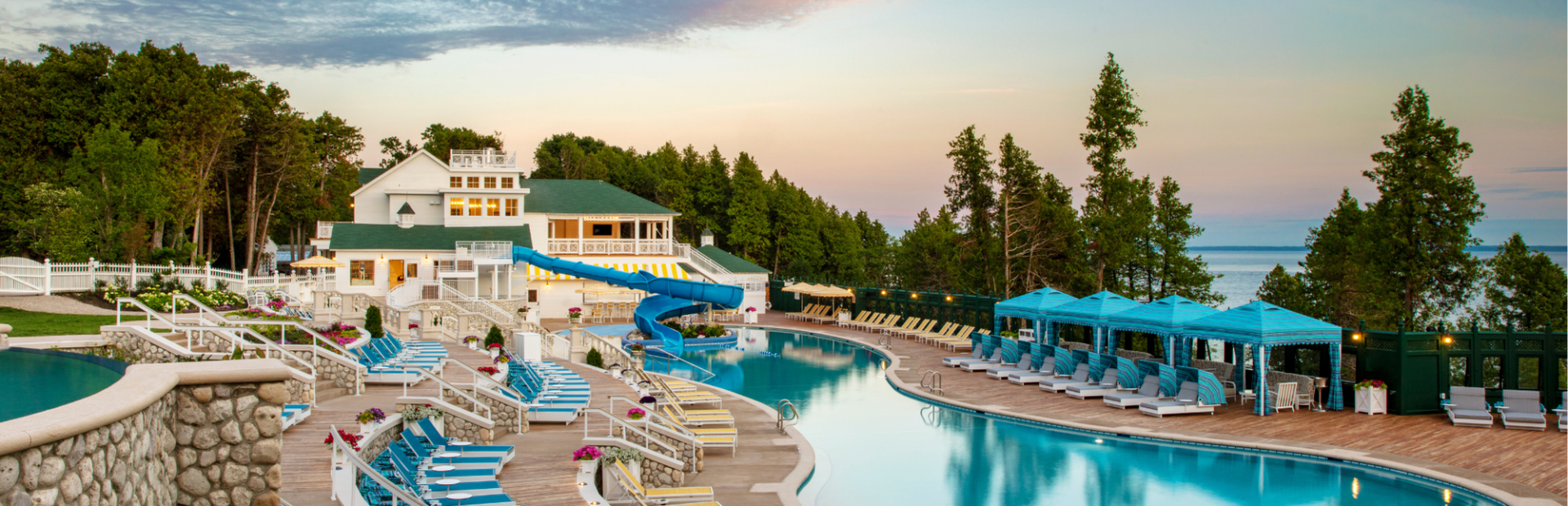 Esther Williams Swimming Pool. Featuring pool cabanas, flowers and the sky.