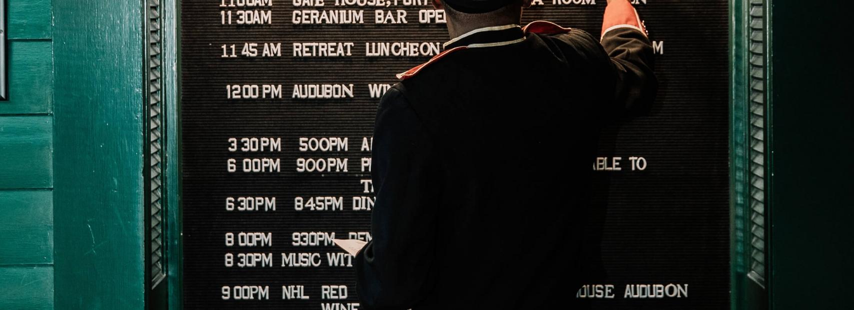 Worker adding daily events to a board