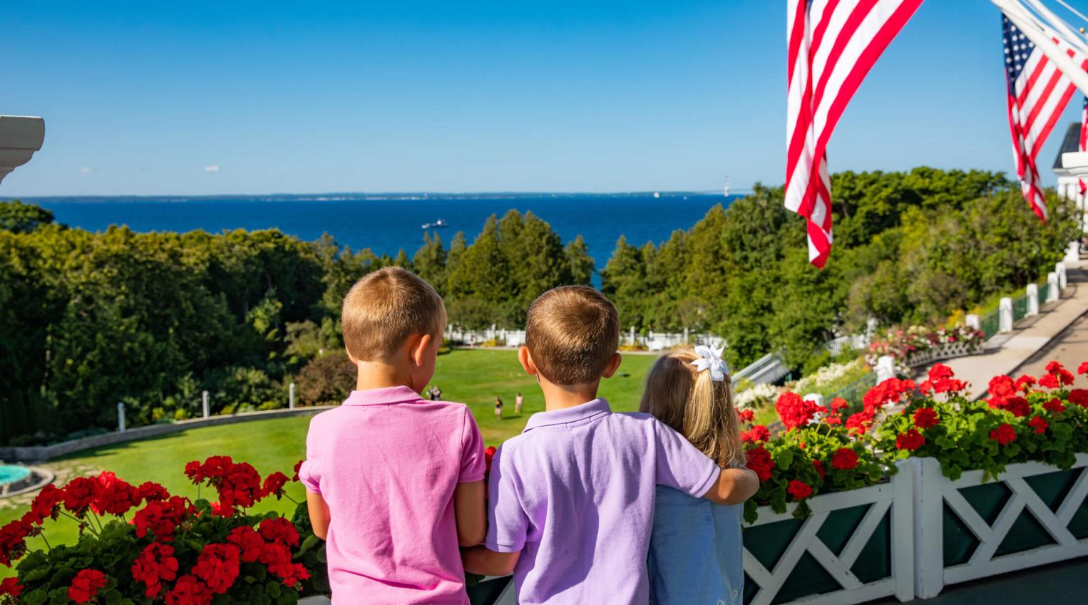 Three kids looking at the lake from front porch