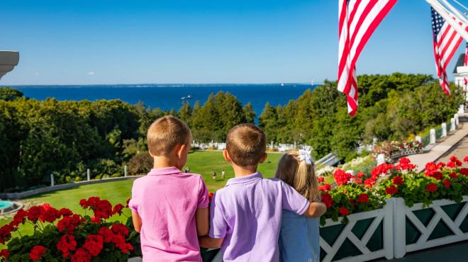 Three kids looking at the lake from front porch