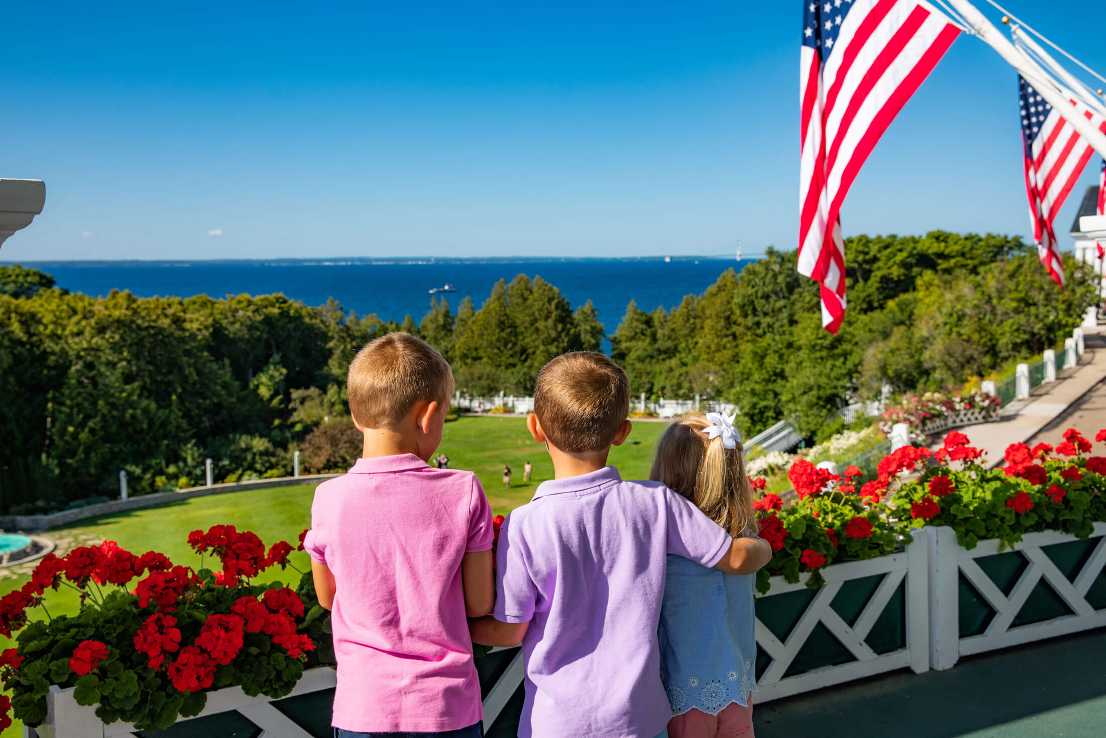 Three kids looking at the lake from front porch