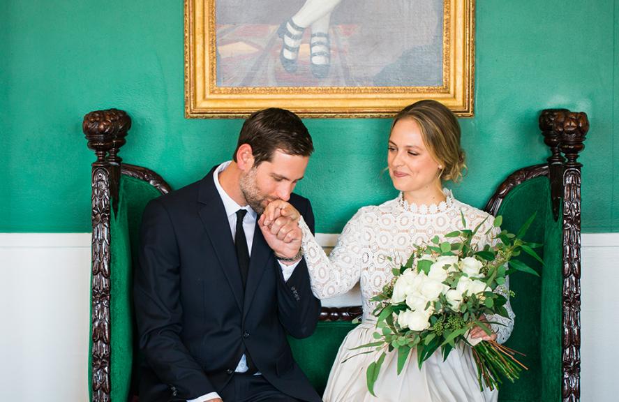 A husband kisses his wife's hand