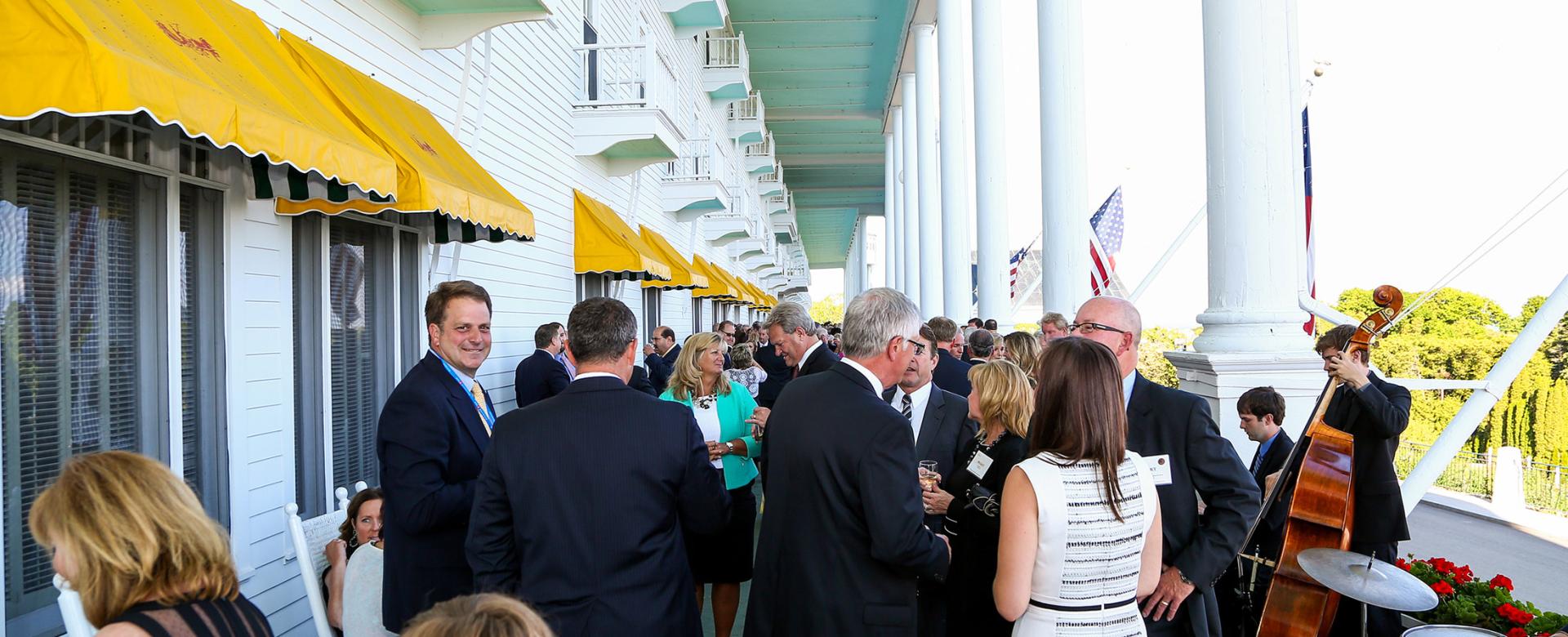 People gathering at en event on the porch