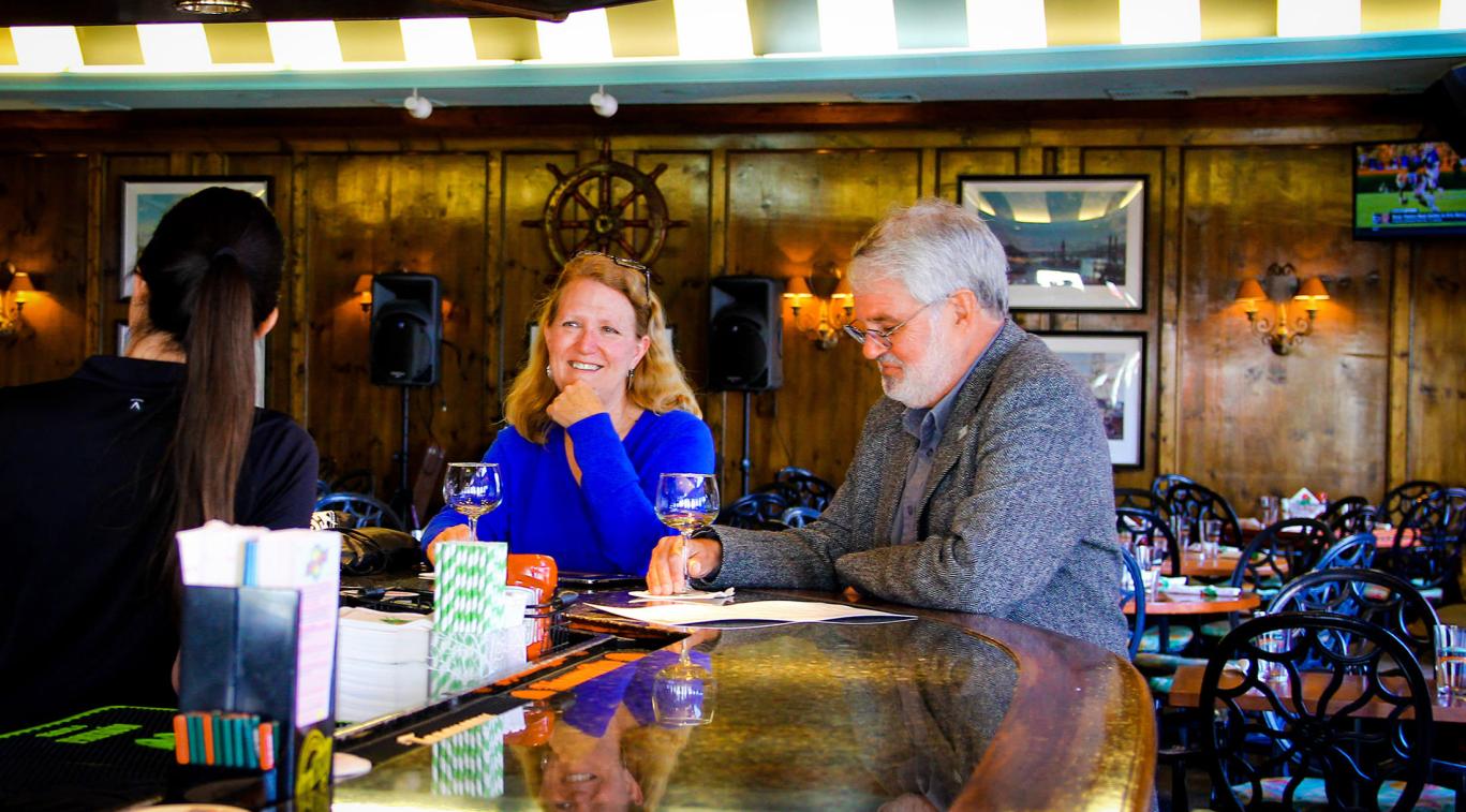 Two adults sitting at the bar in The Gate House