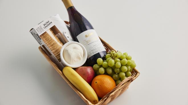 wine basket with fruits, crackers, and cheese