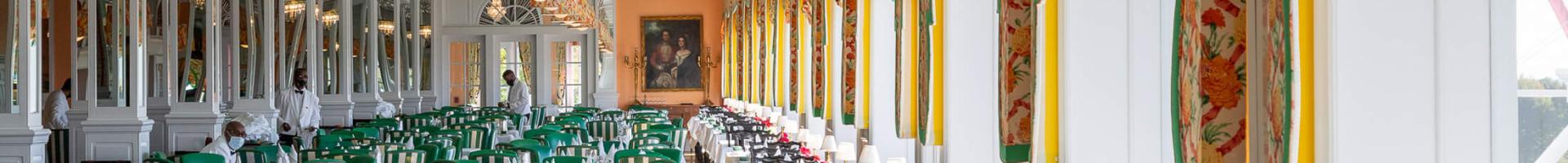 Main Dining Room with green accent chairs.