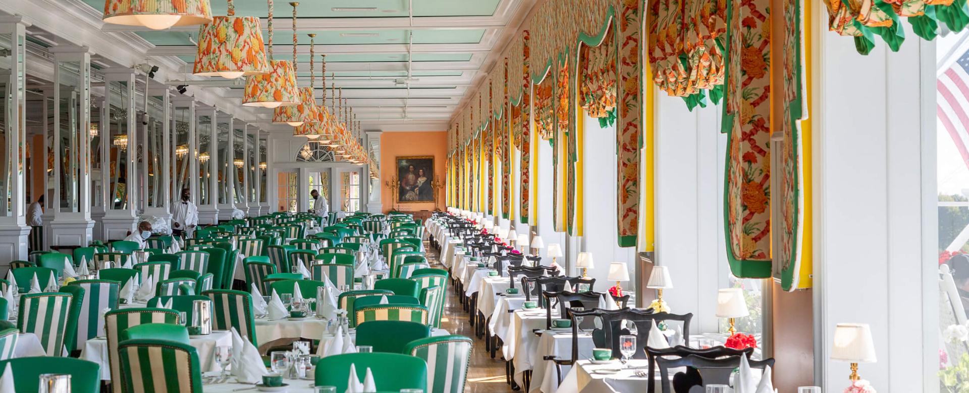 Main Dining Room with green accent chairs.