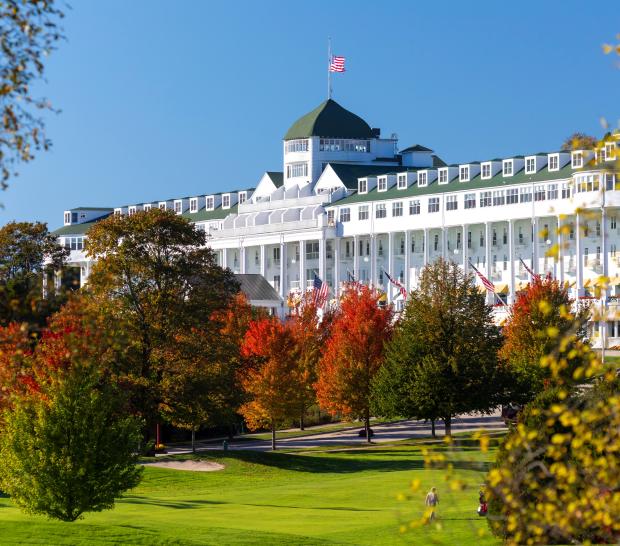 White building surrounded by trees at the Grand Hotel.