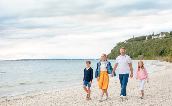 A family enjoys a memorable walk along the shores of Lake Huron during their vacation at Grand Hotel on Mackinac Island.