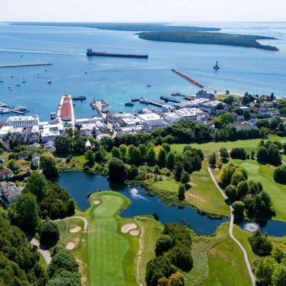 The iconic panoramic view from Grand Hotel, overlooking The Jewel golf course, the harbor town of Mackinac Island, and the Straits of Mackinac.